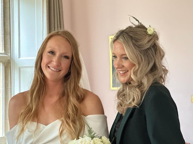 Bride and bridesmaid working ready to leave for wedding