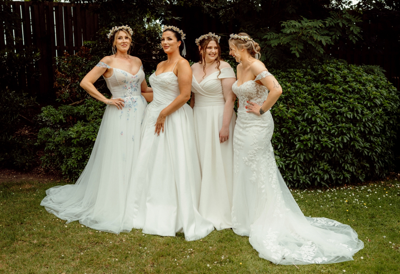 four brides in wedding dresses