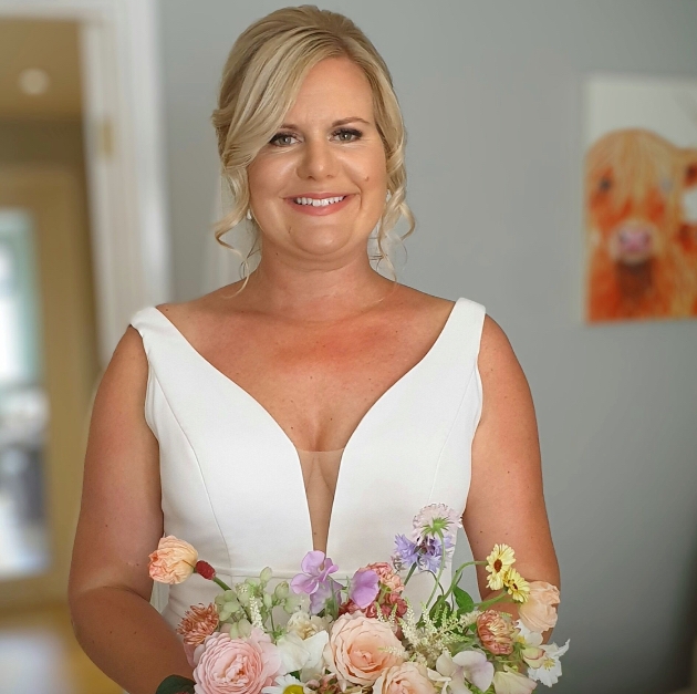 Wedding makeup artist Melinda Hollis creating a bridal hair and makeup look in her studio