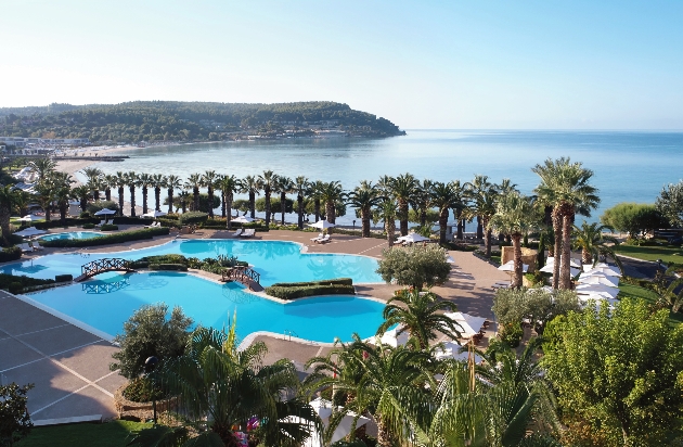 An outdoor swimming pool next to the sea