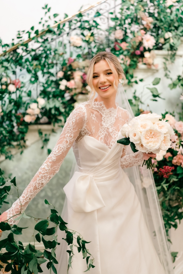 model in wrap corset layered top dress, with lace neckline and sleeves