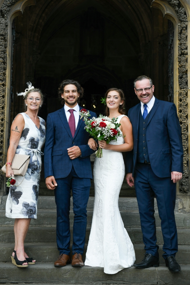 bride groom and parent outside church